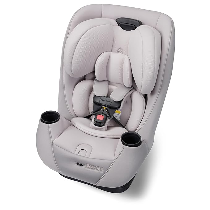 Maxi-Cosi convertible car seat in soft gray fabric, featuring padded headrest, safety harness, and dual cup holders.